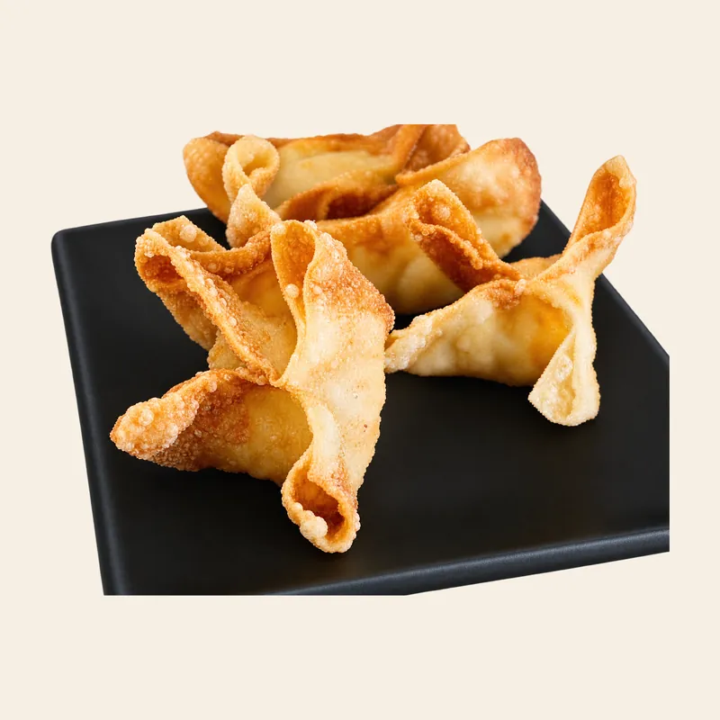 Crisp crab rangoon wontons on a black plate